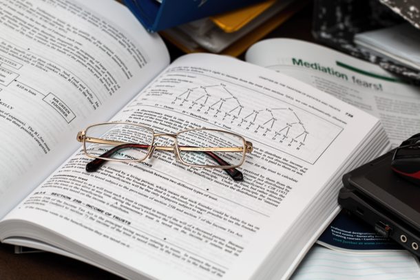 Business Textbook and Glasses